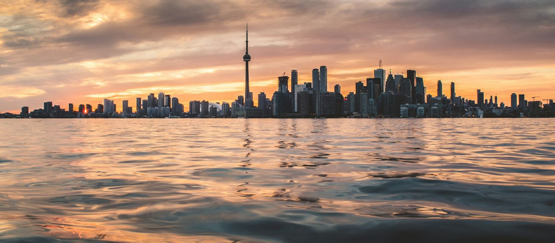 The Toronto skyline across Lake Ontario at sunset